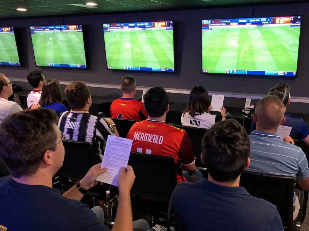 Fans engaging in sports betting excitement while tracking kqbd outcomes in a lively venue